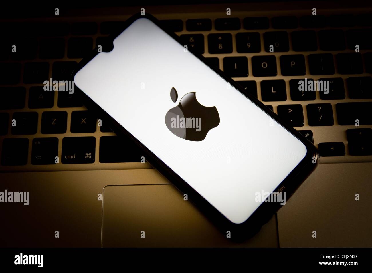 En esta ilustración de la foto, aparece un logotipo de Apple en la pantalla  de un smartphone con un teclado de ordenador en el fondo Fotografía de  stock - Alamy