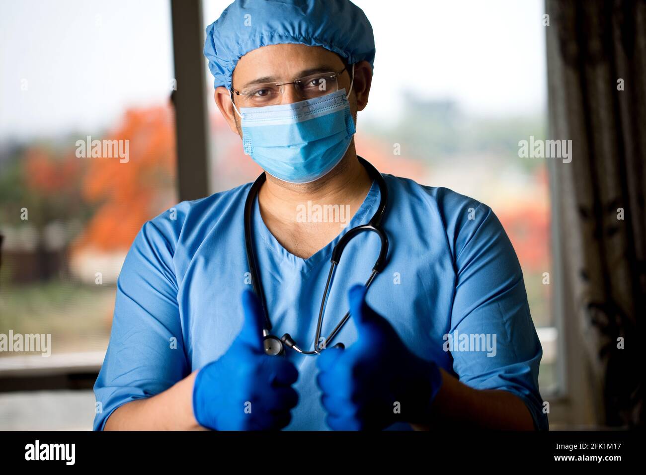 cirujano masculino en mascarilla facial con brazos Foto de stock