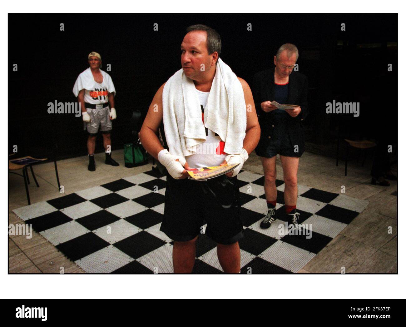 Torneo de boxeo de cuello blanco DE LA PENA CAPITAL Julio 2000Three de los hombres de negocios esperando su llamada al ring (izquierda) Anthony Pellegrino (59) EE.UU. Un electricista de Nueva York, (centro) Alex Puchall (42) Gerente General del Hotel de Nueva Jersey y (derecha) Roger Moore (55) un contador retirado de Berkshire. El evento DE LA PENA CAPITAL El primer torneo de boxeo de cuello blanco del Reino Unido, celebrado en Broadgate Arena, Londres. Foto de stock