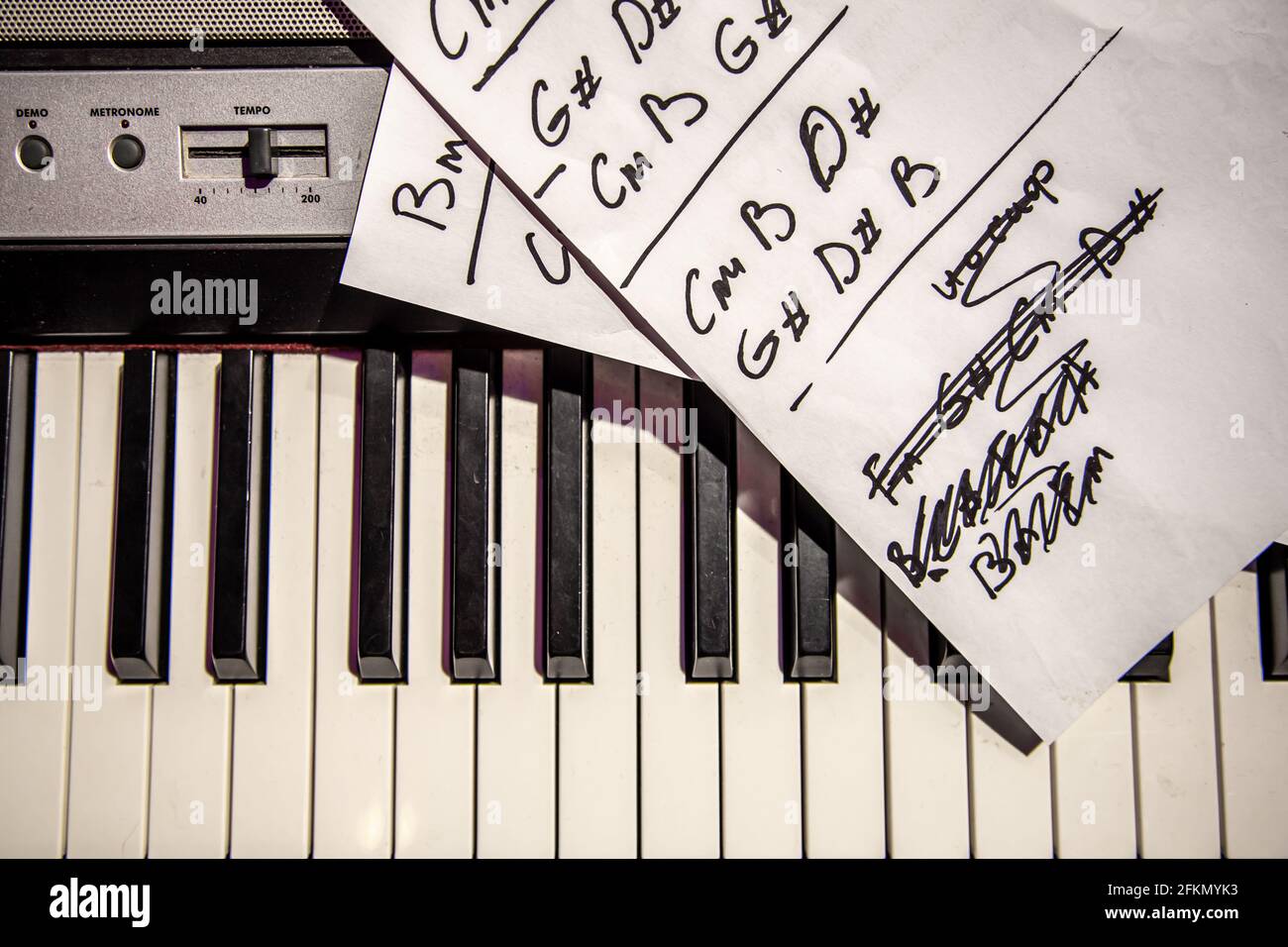Un primer plano de un folleto con acordes escritos a mano se encuentra en  las teclas de piano Fotografía de stock - Alamy
