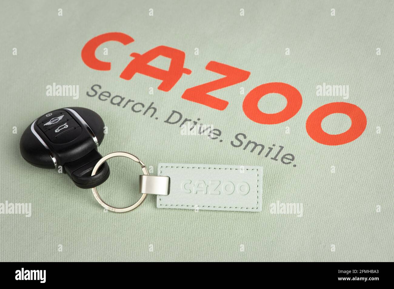 El logotipo de Cazoo, minorista de automoción en línea, como se ve en una de las bolsas de mano y llavero de la empresa. Foto de stock