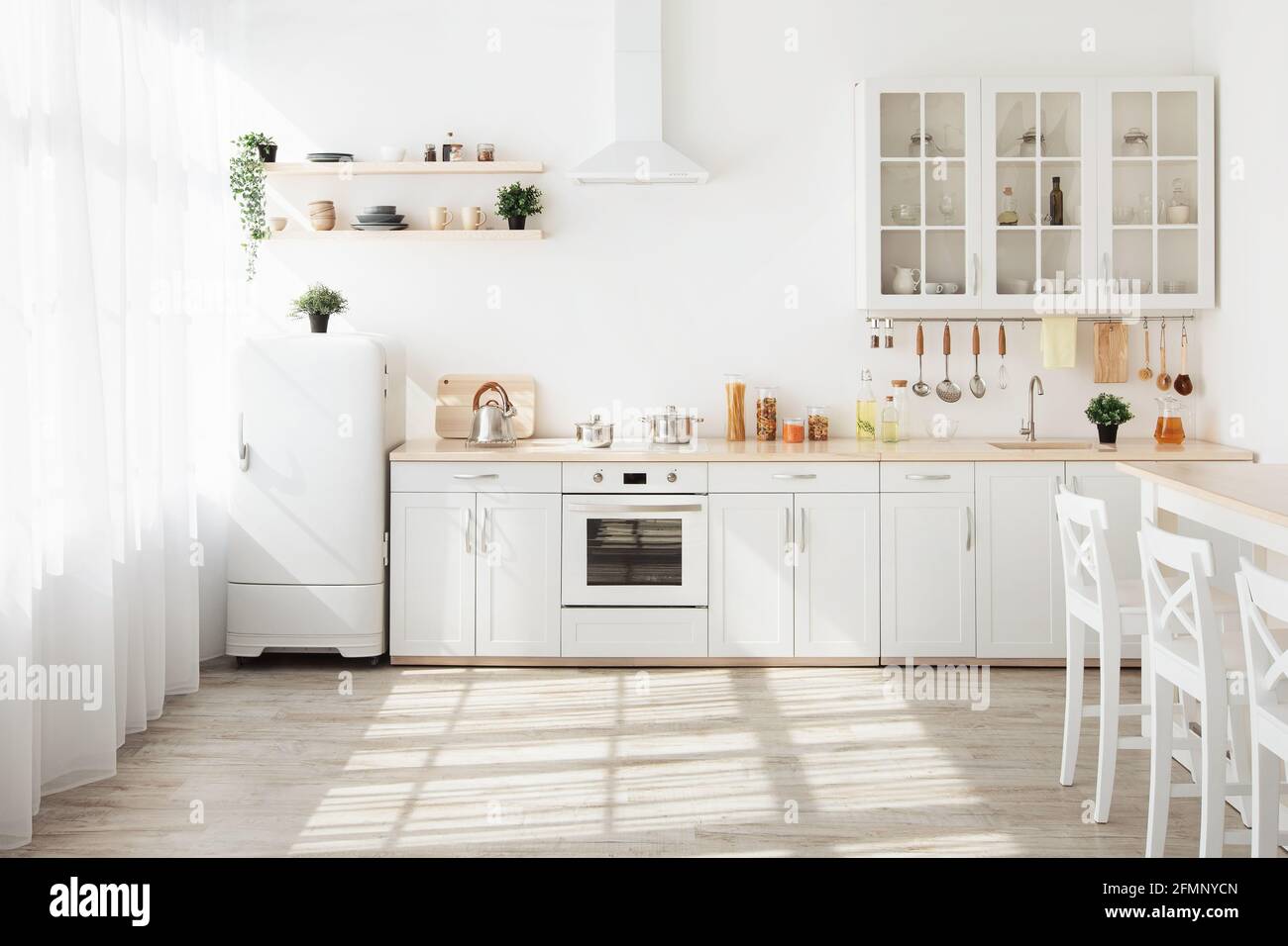 https://c8.alamy.com/compes/2fmnycn/cocina-con-paredes-claras-muebles-blancos-y-una-pequena-nevera-en-el-comedor-de-diseno-escandinavo-2fmnycn.jpg