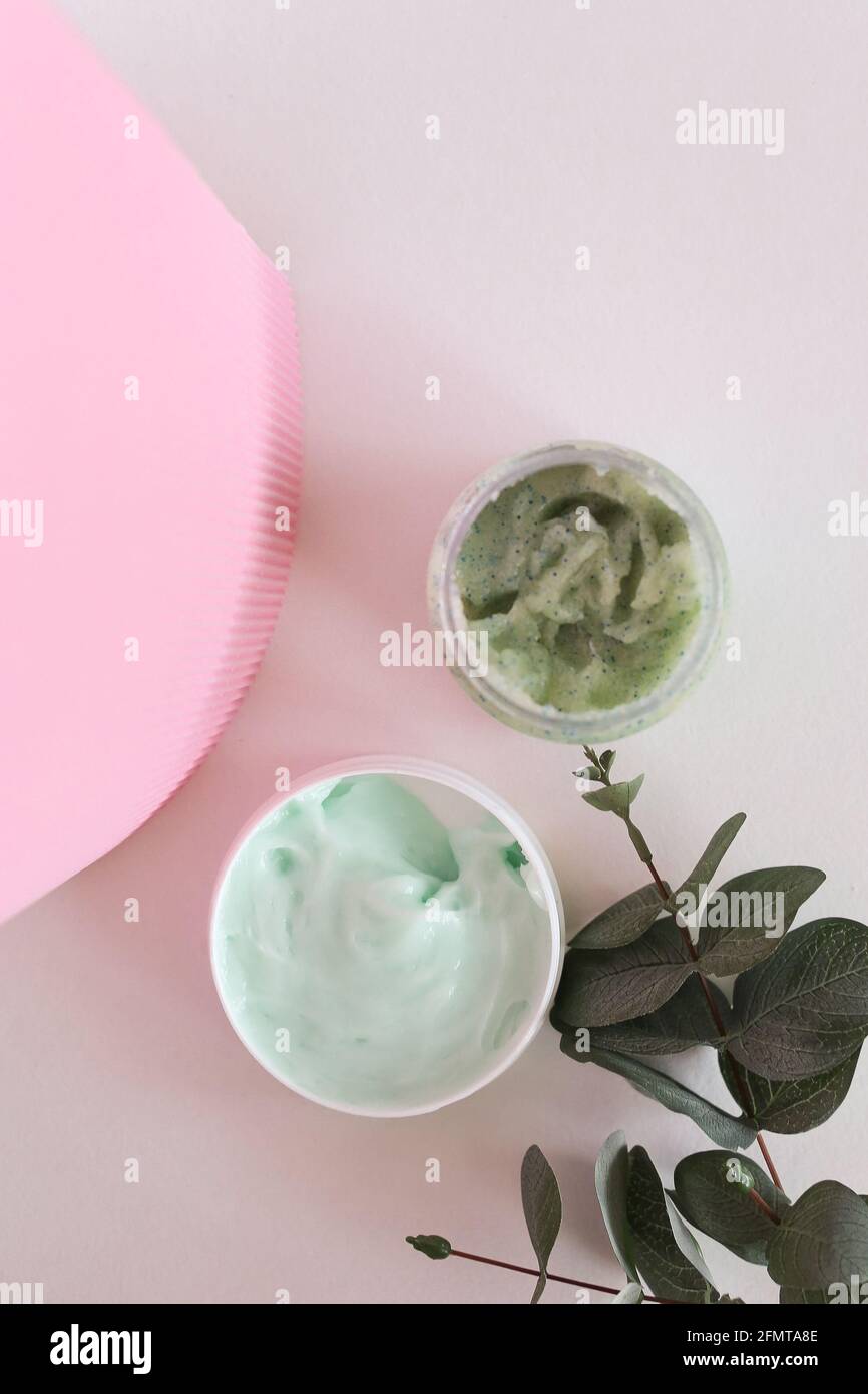Crema cosmética hidratante con eucalipto se apoya sobre fondo neutro salpicaduras de leche Fotografía de stock - Alamy