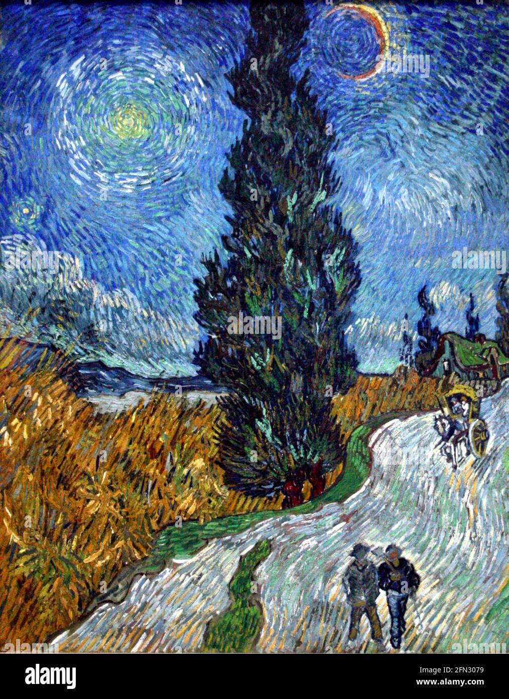 Vincent van Gogh obras de arte titulado Road with Cypress o Country Road en Provenza por la noche. Dos figuras caminan por un carril campestre en este vibrante paisaje. Foto de stock