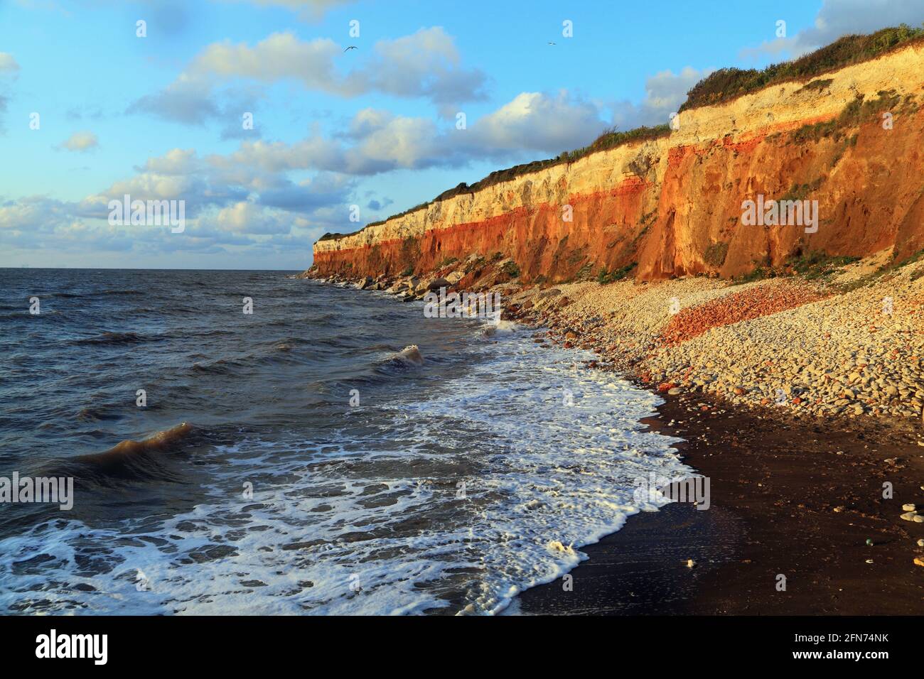 Hunstanton Cliffs, patrón de rayas, olas, marea alta, surf, The Wash, Mar del Norte, Norfolk, Inglaterra, Reino Unido Foto de stock