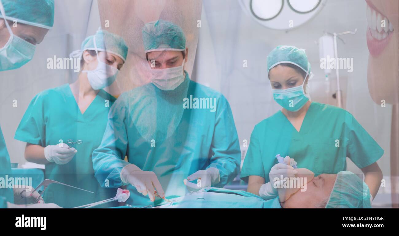 Composición de cirujanos en mascarillas sobre paciente masculino en  quirófano Fotografía de stock - Alamy