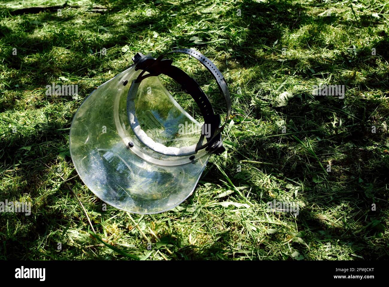 máscara protectora de plástico para segar hierba, en verano Foto de stock
