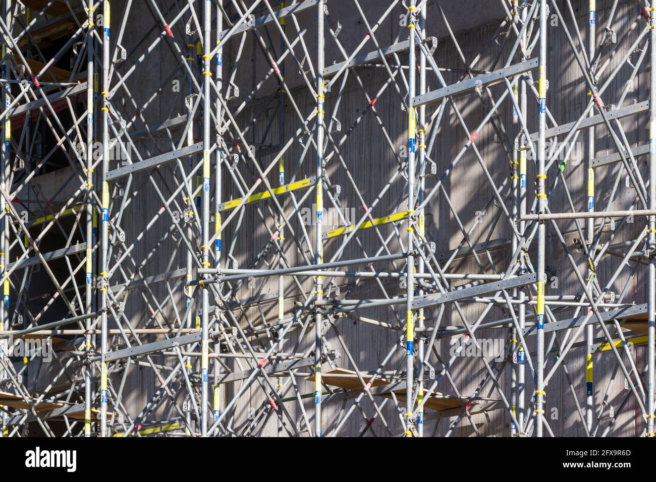 Cierre de andamios metálicos junto a edificios de hormigón, obra de construcción, Hungría, Europa Foto de stock