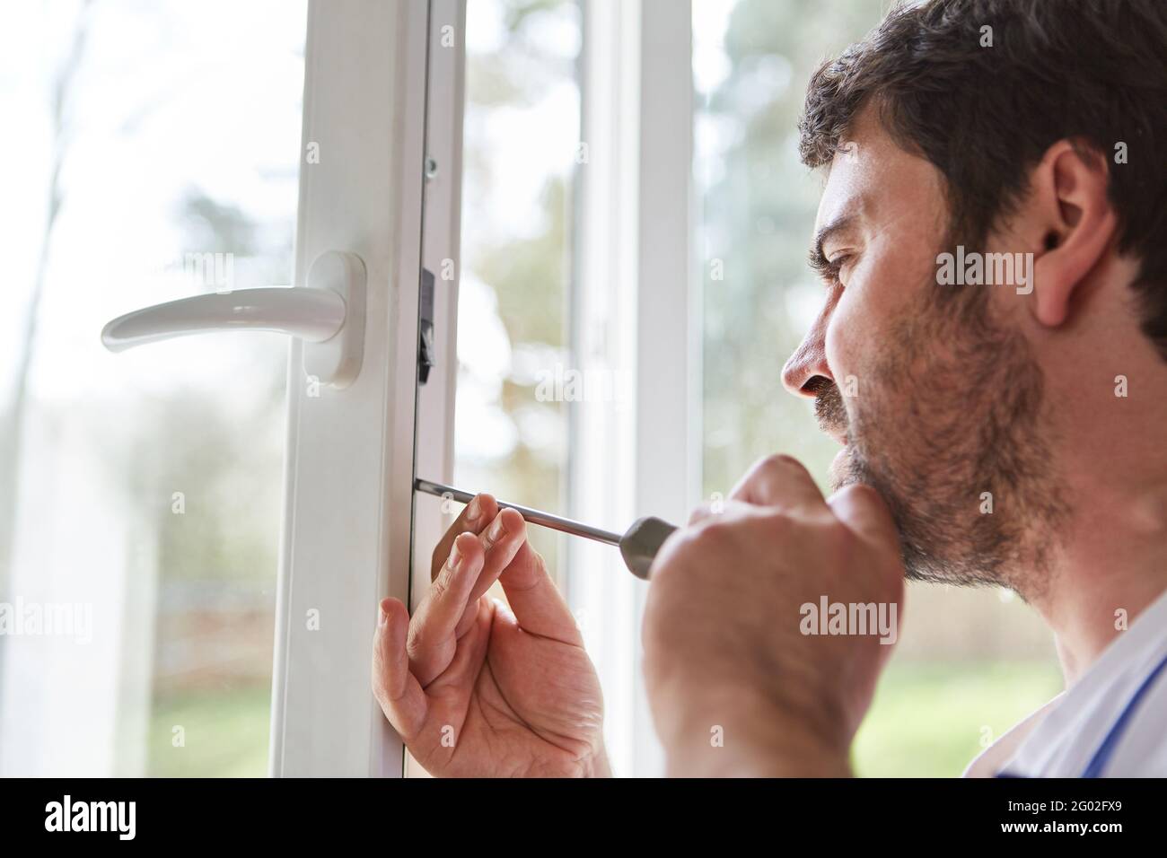 Los montadores de ventanas o los ajustadores de ventanas ajustan y ajustan las ventanas en un apartamento Foto de stock