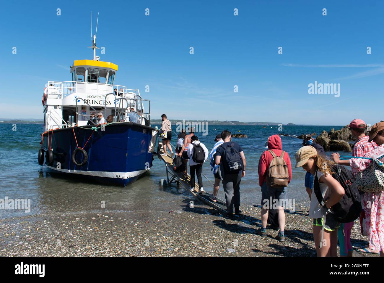 Plymouth Princess con pasajeros a pie que se embarcan desde la playa hacia el transbordador Kingsand y Cawsand. Foto de stock