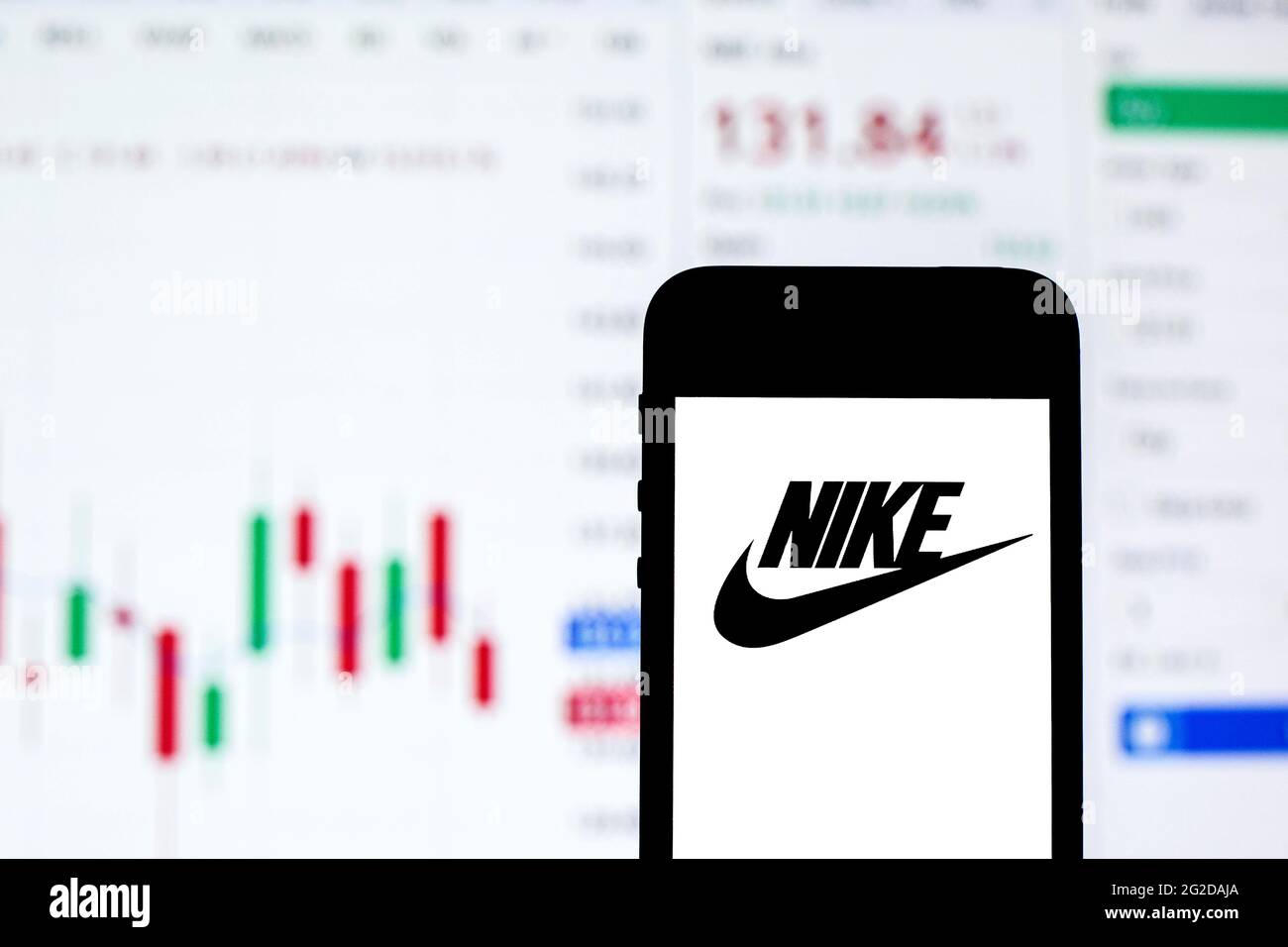 En esta ilustración de la foto se muestra un logotipo de Nike en un  smartphone con la información sobre el mercado de valores de Nike en  segundo plano Fotografía de stock -