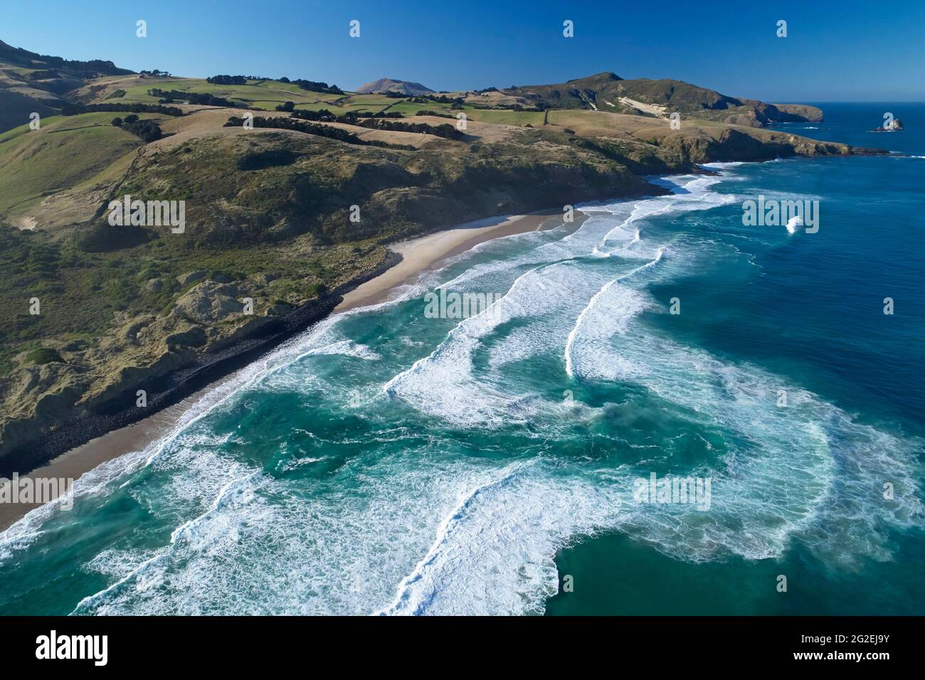 Fuerte corriente de rasgadura, Boulder Beach, Otago Peninsula, Dunedin, South Island, Nueva Zelanda - antena de drone Foto de stock