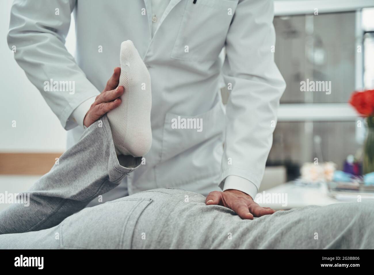 Estiramiento pasivo de los cuadriceps realizado por un médico osteopático Foto de stock