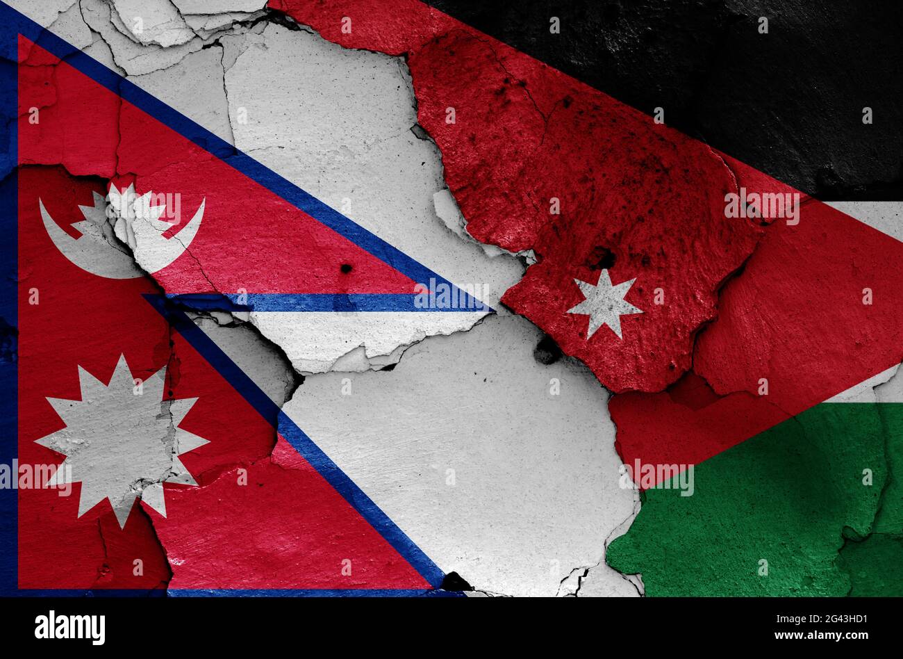 Banderas de Nepal y Jordania pintadas en la pared agrietada Foto de stock