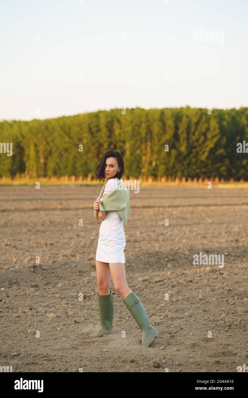 Mujer asiática, caminando por el campo, vistiendo un vestido blanco y botas  de agua verdes Fotografía de stock - Alamy