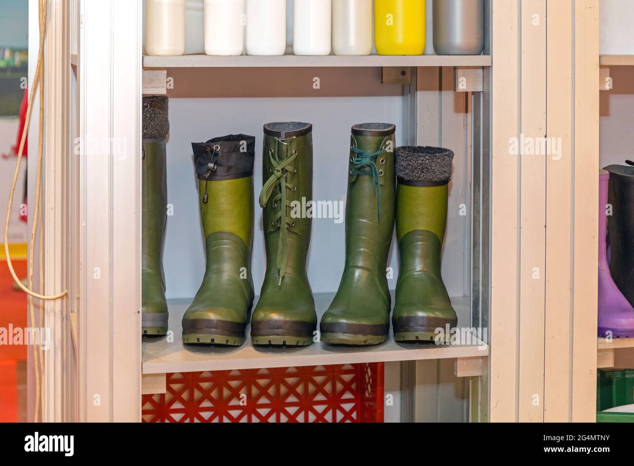 Botas de lluvia de caucho verde en el equipo de trabajo de estante  Fotografía de stock - Alamy