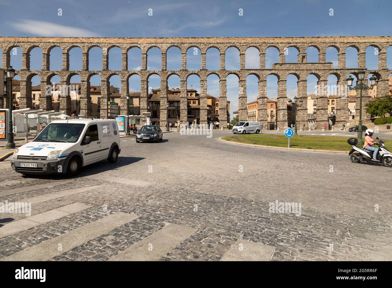 Segovia, España - 2 de junio de 2021: Vista general del Acueducto de Segovia, en un día soleado, y la rotonda para el tráfico junto a la Plaza del Azogejo Foto de stock