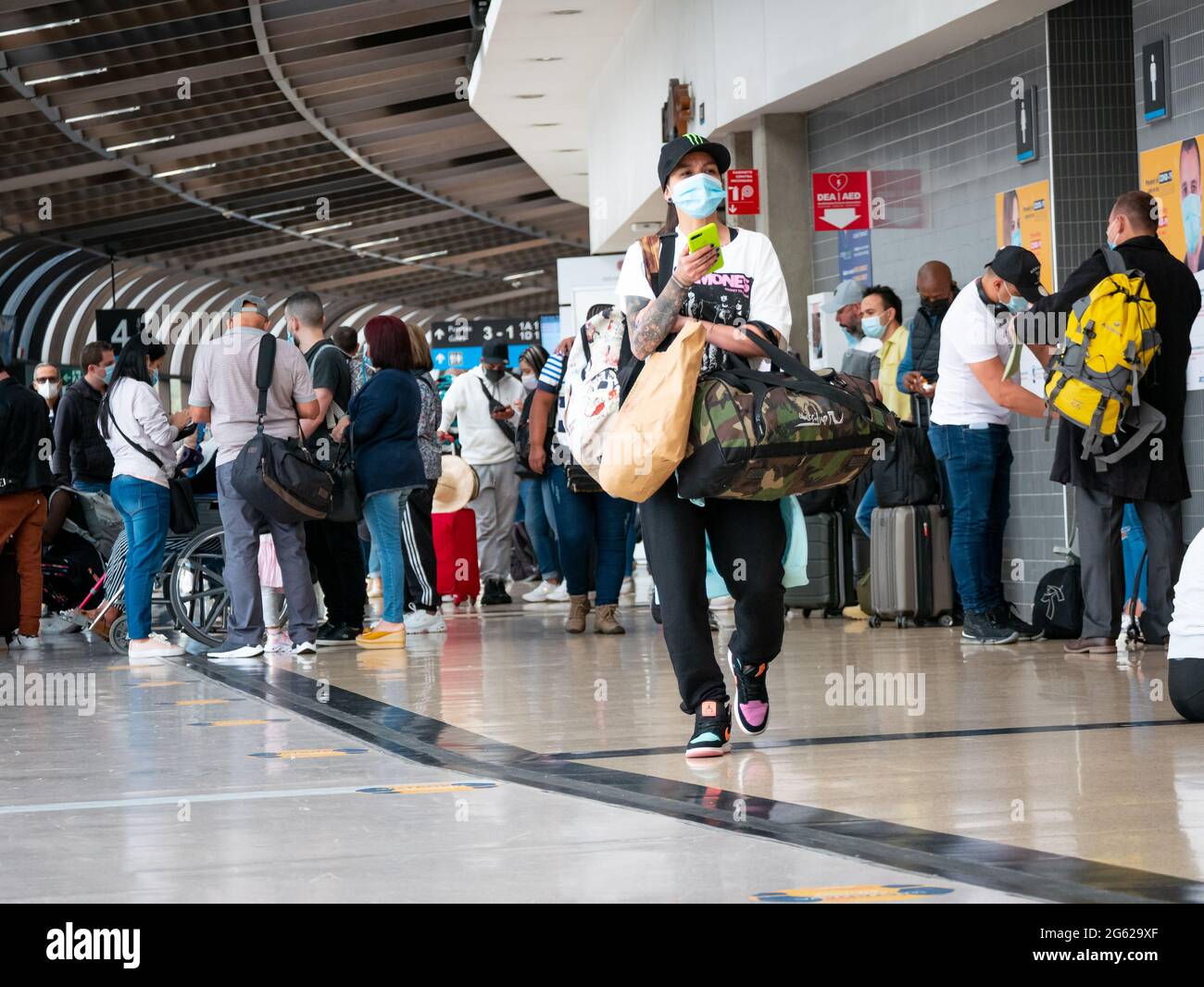 Medellín, Antioquia, Colombia - Mayo 17 2021: Mujer Latina máscara camina con sus maletas en la terminal del aeropuerto José María Cordova Fotografía de stock - Alamy