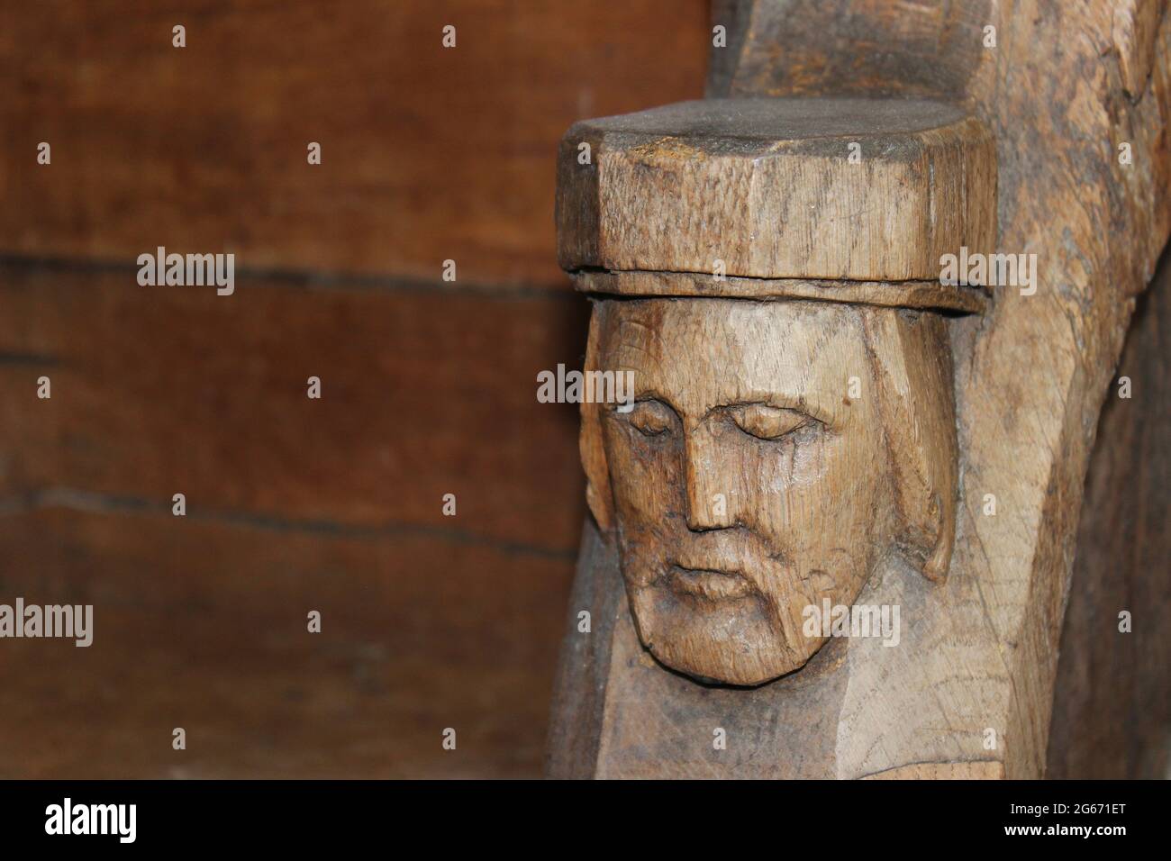 Detalle de cabeza tallada en el coro de la estall que data del siglo 16th en St Beunos, Clynnog Fawr, Gales Foto de stock