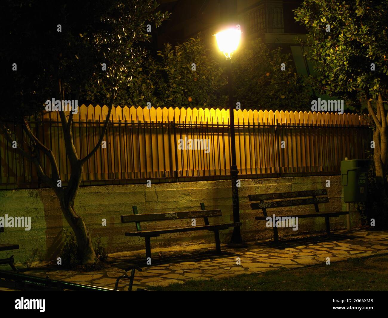 Bancos de parque y lámpara de calle en xantates, Corfú, Grecia por la noche Foto de stock