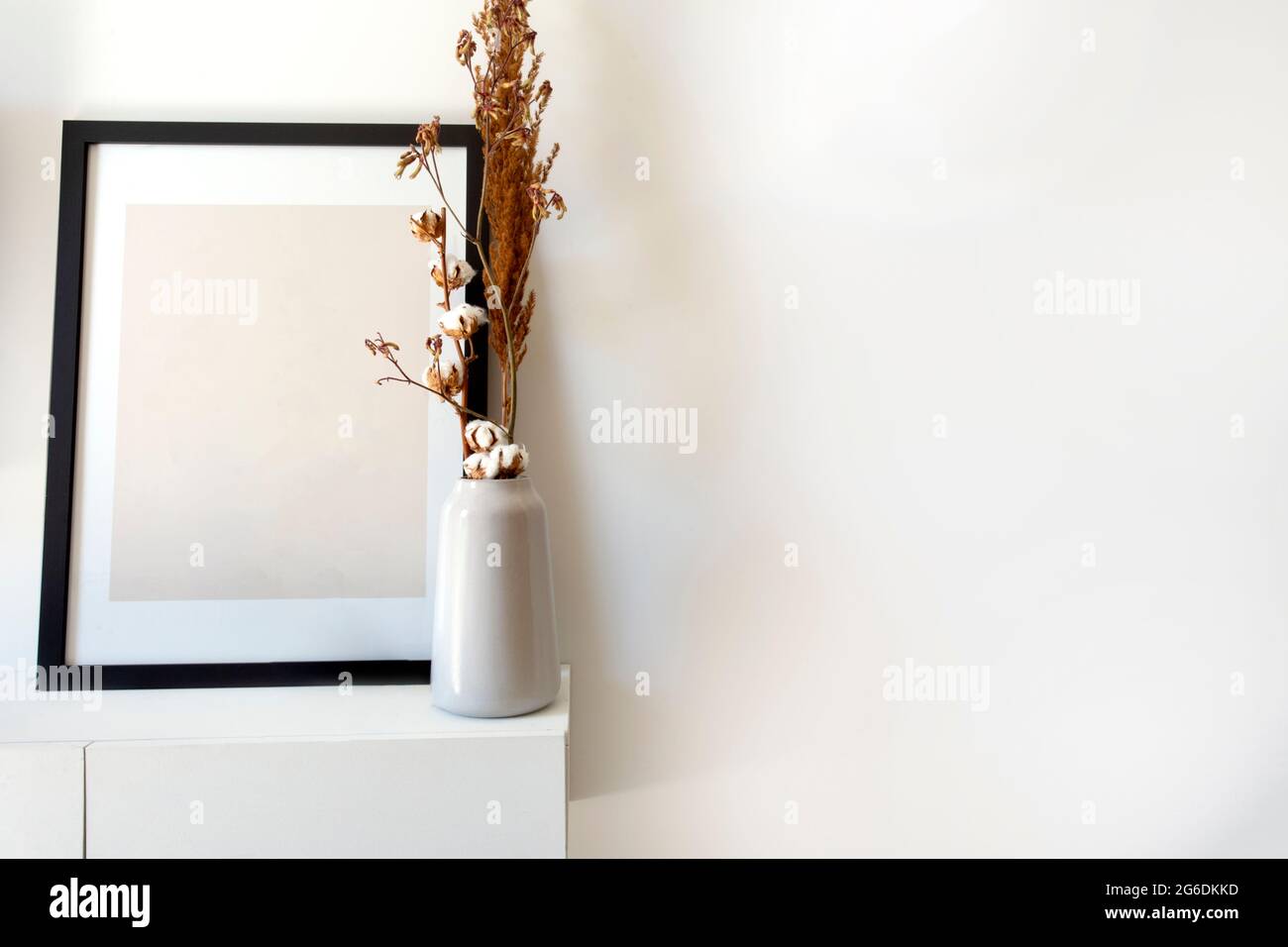 Foto de madera vacía, maqueta de marco con jarrón blanco y elegante planta cerca de la pared blanca en la mesa, Copiar espacio decoración interior moderna Foto de stock
