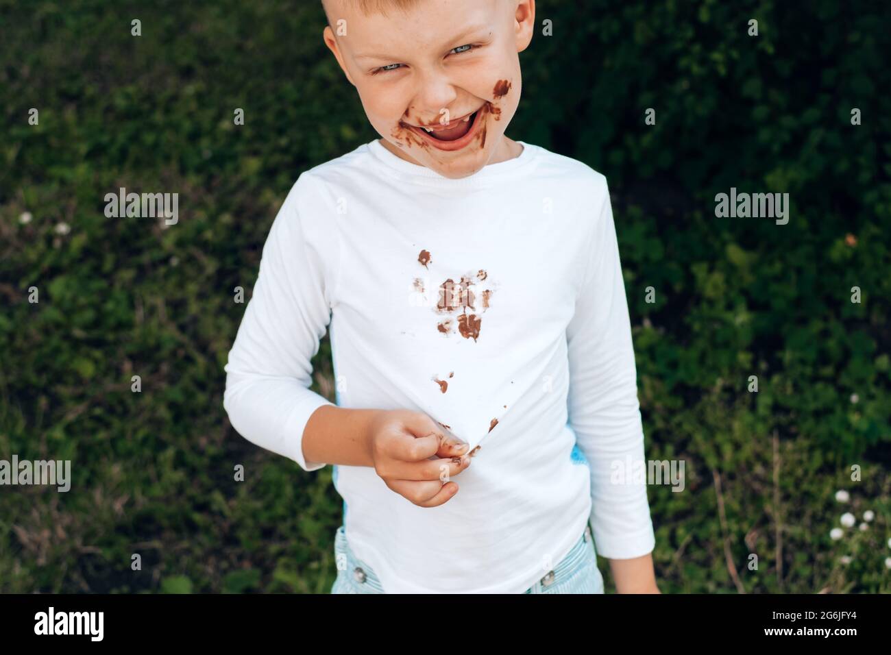 Federal Pensar Donación Niño mostrando manchas de chocolate en ropa blanca, suciedad en su cara.  Fotografías de alta calidad Fotografía de stock - Alamy
