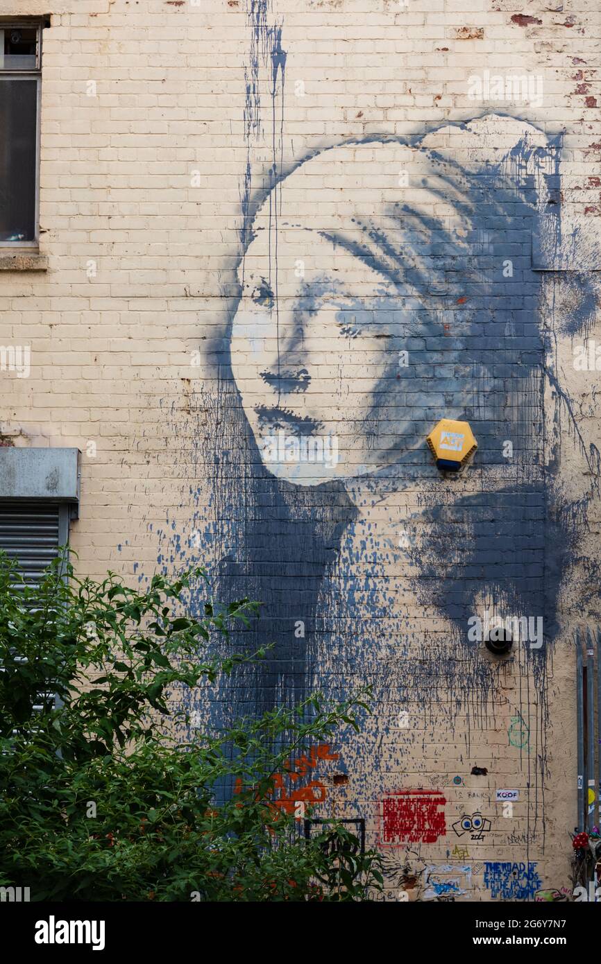El graffiti Banksy, La chica con el tímpano perforado, Albion Docks, Bristol ciudad, Inglaterra Foto de stock