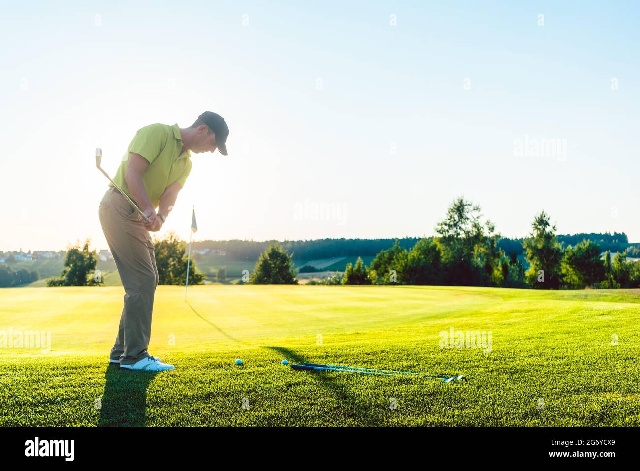 Vista trasera completa de un golfista experimentado que golpea la
