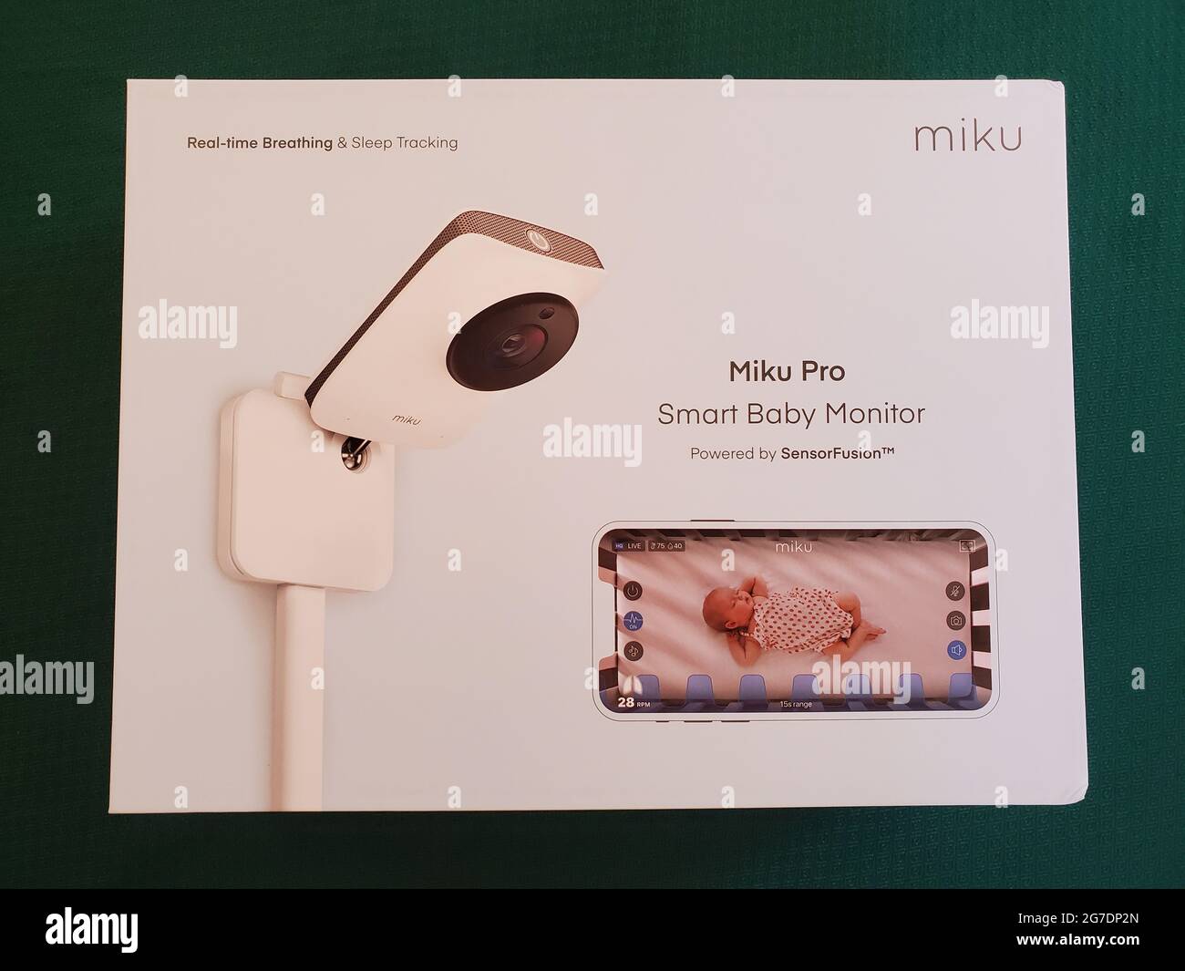 Fotografía de un paquete 'Miku Pro Smart Baby Monitor', desde arriba, descansando sobre un fondo verde en Lafayette, California, 14 de abril de 2021. () Foto de stock