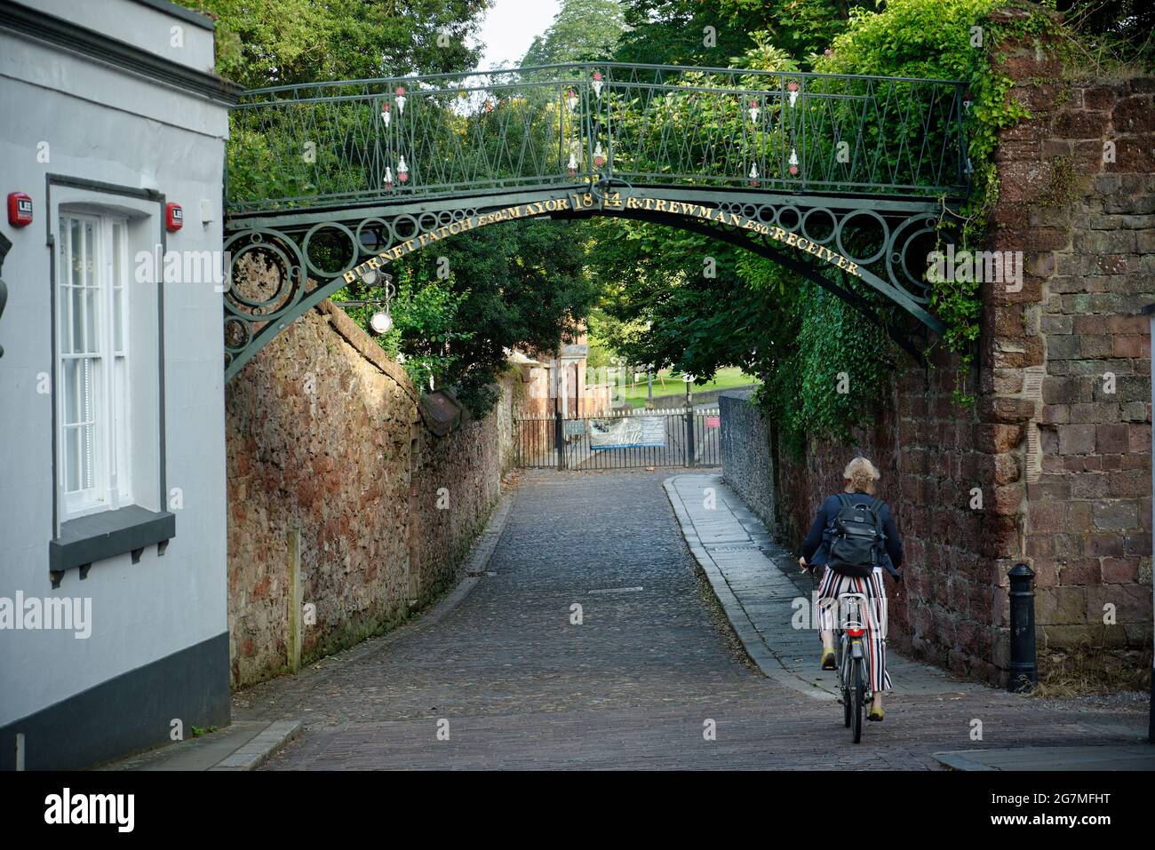 Un viejo puente de hierro forjado en Exeter, Devon, Inglaterra, Reino Unido con un ciclista. Foto de stock