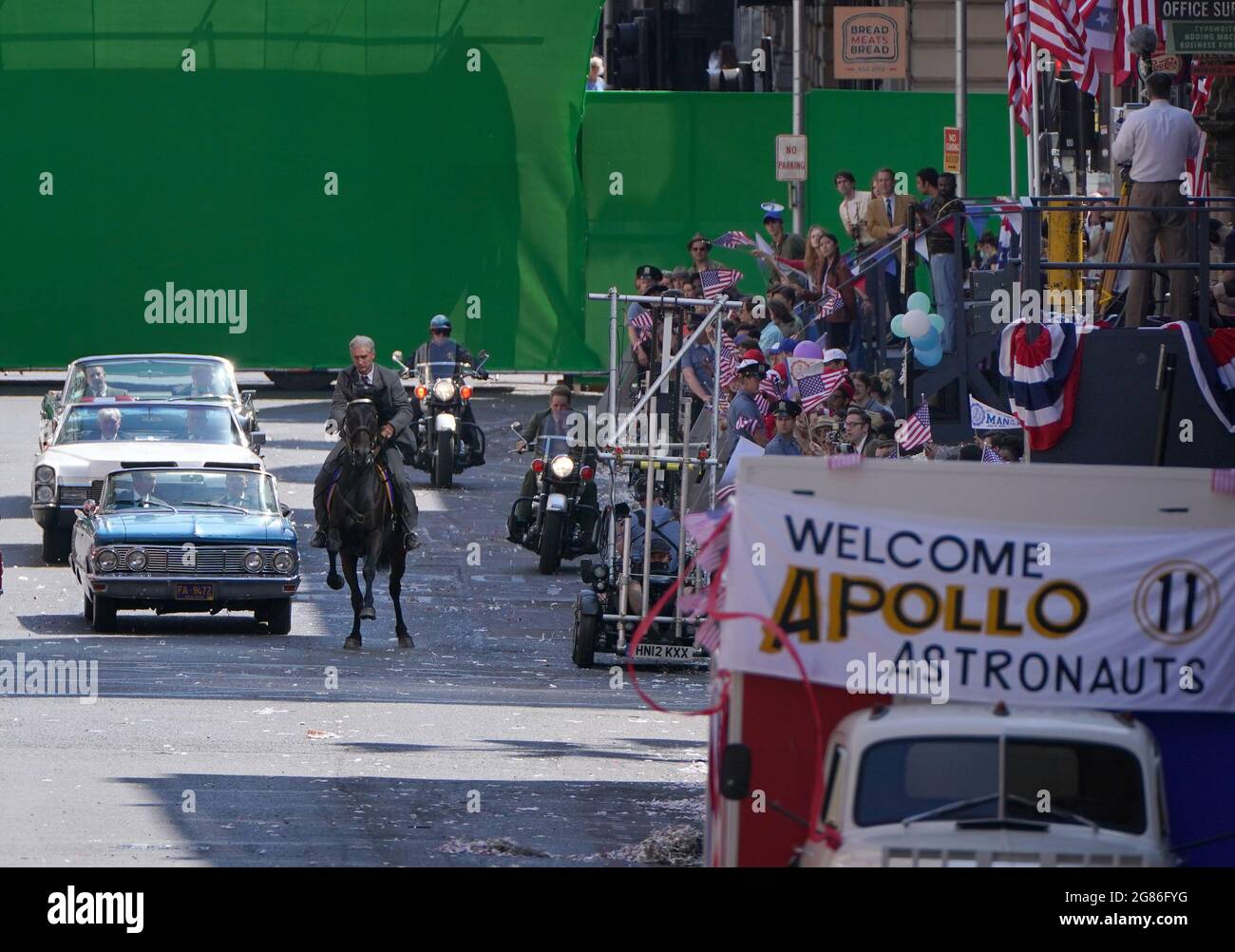 Un doble cuerpo para Harrison Ford y Boyd Holbrook se ven en un caballo y moto durante una escena de desfile en St Vincent Street en el centro de la ciudad de Glasgow durante el rodaje de lo que se cree que es la nueva película de Indiana Jones 5 protagonizada por Harrison Ford. Fecha de la foto: Sábado 17 de julio de 2021. Foto de stock