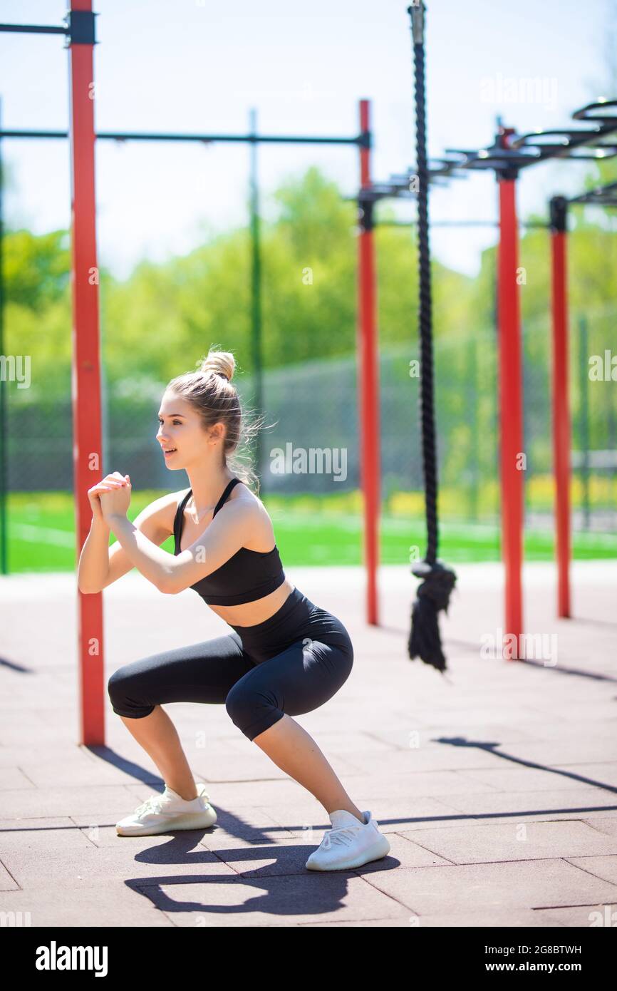 Gimnasio al aire libre, parque de verano. Mujer vestida ropa deportiva en  el exterior en el campo deportivo del simulador. Sana y sosa Fotografía de  stock - Alamy