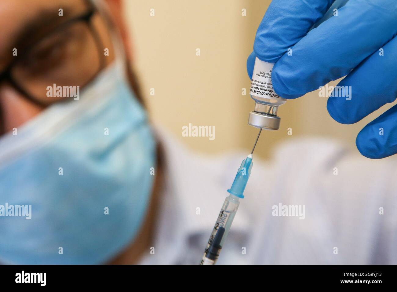 El trabajador de salud del NHS se prepara para administrar la vacuna Pfizer/ BioNTec Covid-19 a un miembro del público en un centro de vacunación en Londres. Foto de stock