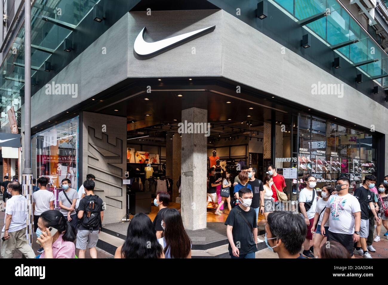 Hong Kong, China. 28th de julio de 2021. Los peatones pasan por delante de  la marca de ropa deportiva multinacional americana, la tienda Nike y su  logotipo visto en Hong Kong. (Foto