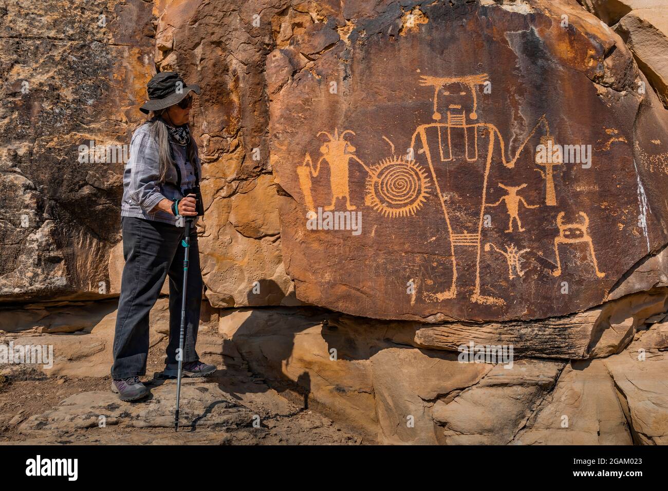 Karen Rentz con un espectacular panel de petroglifos en el sitio de petroglifos de McKee Spring, Monumento Nacional de Dinosaurios, Utah, Estados Unidos Foto de stock