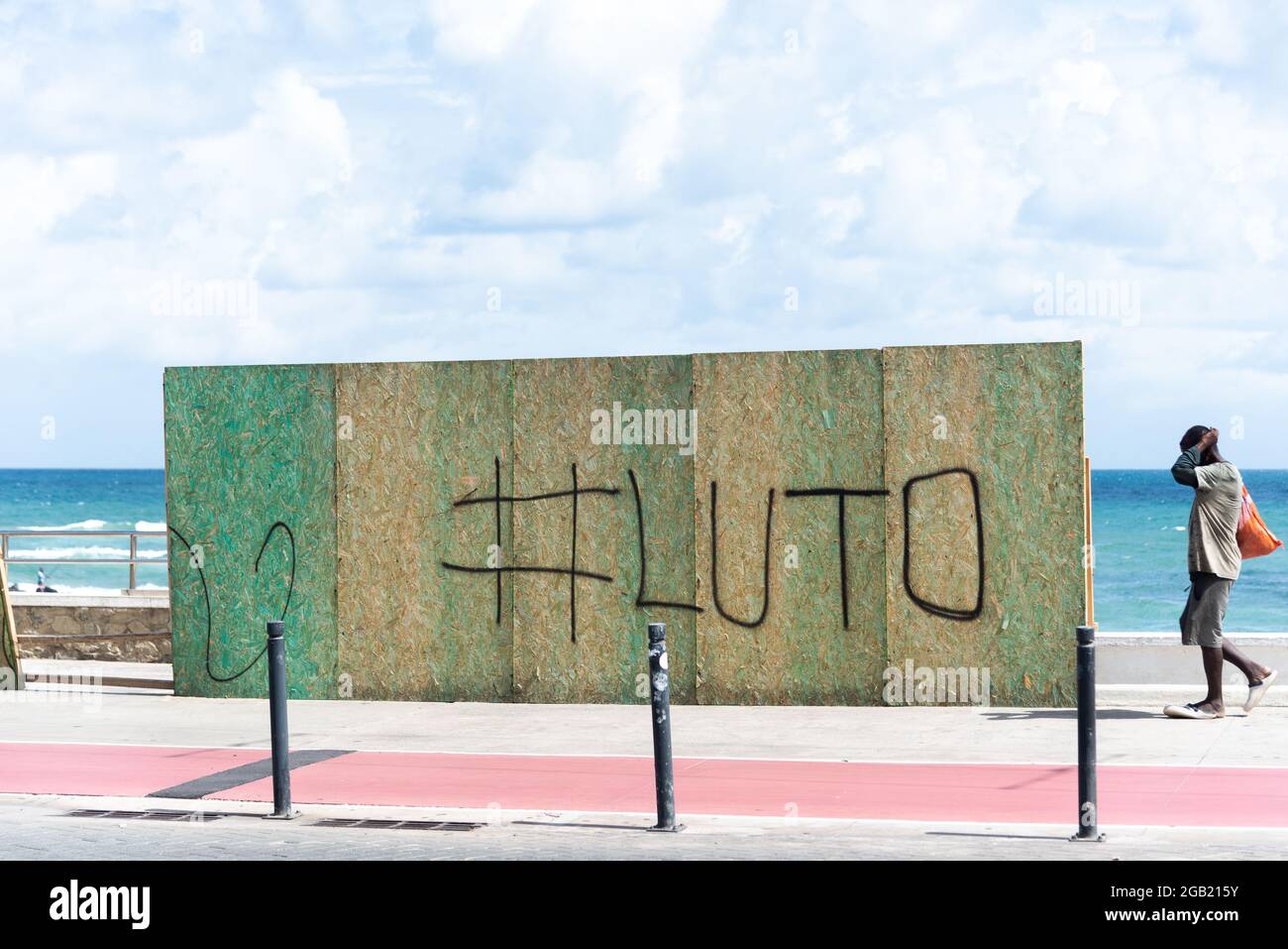 Salvador, Bahia, Brasil - 01 de mayo de 2021: Revestimiento para impedir el acceso a la playa graffiti con la palabra 'luto', en honor a los miles de personas kill Foto de stock
