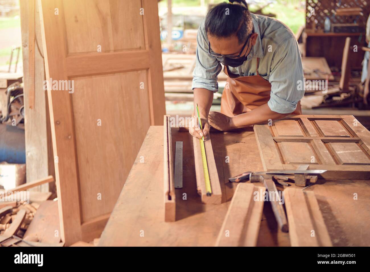 Carpintero utilizando pistola para disparar los clavos en la madera  contrachapada siding Fotografía de stock - Alamy