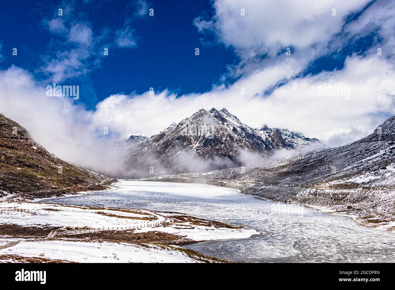 el lago congelado de sela con montañas nevadas y cielo azul brillante por la mañana desde un ángulo plano se toma en sela tawang arunachal pradesh india. Foto de stock