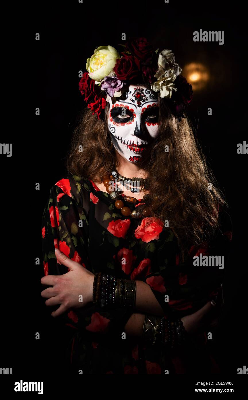 Mujer en Santa Muerte maquillaje sobre fondo negro. Chica que lleva traje  tradicional mexicano de muerte santa para halloween Fotografía de stock -  Alamy