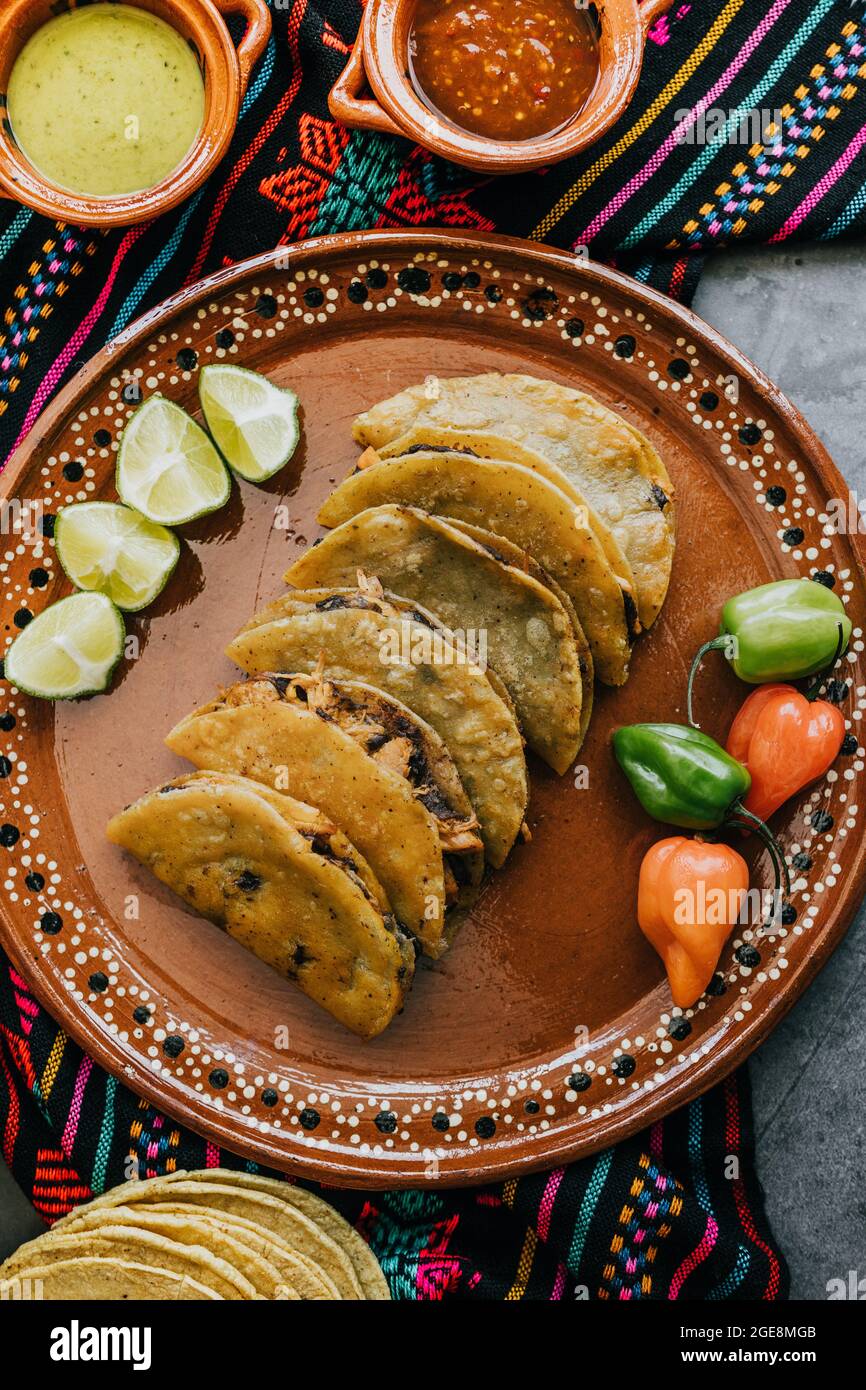 Tacos mexicanos fritos o dorados con limón y salsa, comida mexicana tradicional en México