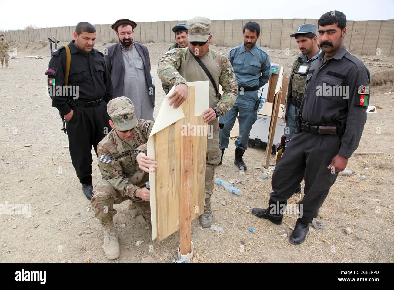 Soldados del Ejército de EE.UU. Asignados a las Fuerzas de Seguridad asesoran y ayudan al Equipo 28, Fuerza de Tarea 3/101, despardar a una Policía Uniformada Afgana objetivo, asignada a la ciudad de Khost, para disparar durante un fuego vivo en la zona de armas pequeñas en Camp Parsa, provincia de Khowst, Afganistán, 30 de enero de 2013. La gama permitió a la AUP practicar su marksmanship con pistolas Beretta M-9 y rifles AK-47. (EE.UU Foto del ejército por Sgt. Kimberly Trumbull / Lanzada) Foto de stock