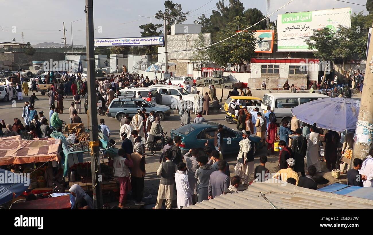 Kabul, Afganistán. 21st de agosto de 2021. Combatientes talibanes vigilan mientras los afganos se reúnen fuera del aeropuerto internacional Hamid Karzai para huir del país, en Kabul, Afganistán, el sábado 21 de agosto, 2021. Foto de Bashir Darwish/ Crédito: UPI/Alamy Live News Foto de stock