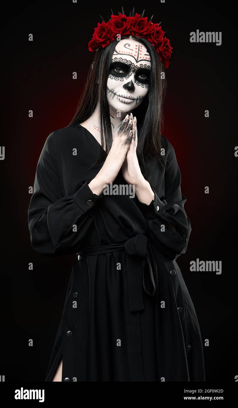 Mujer joven con maquillaje de calavera (cráneo de azúcar). La bruja con  muertos (fuerte) grasepaint vestido negro. Día de los muertos (y Halloween)  tema Fotografía de stock - Alamy