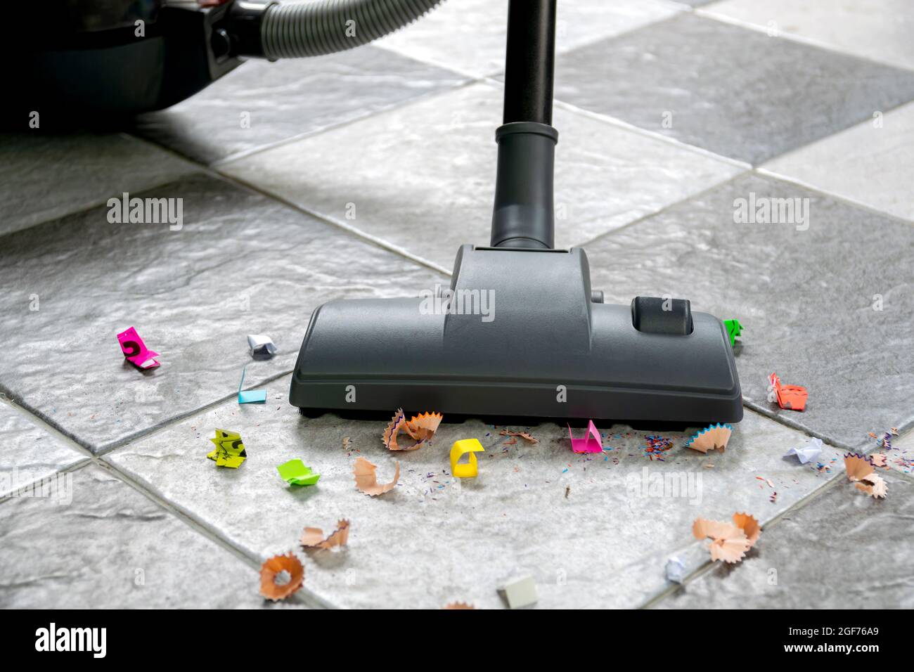 Barre los restos de papel y el polvo en suelos de baldosas con una  aspiradora Fotografía de stock - Alamy