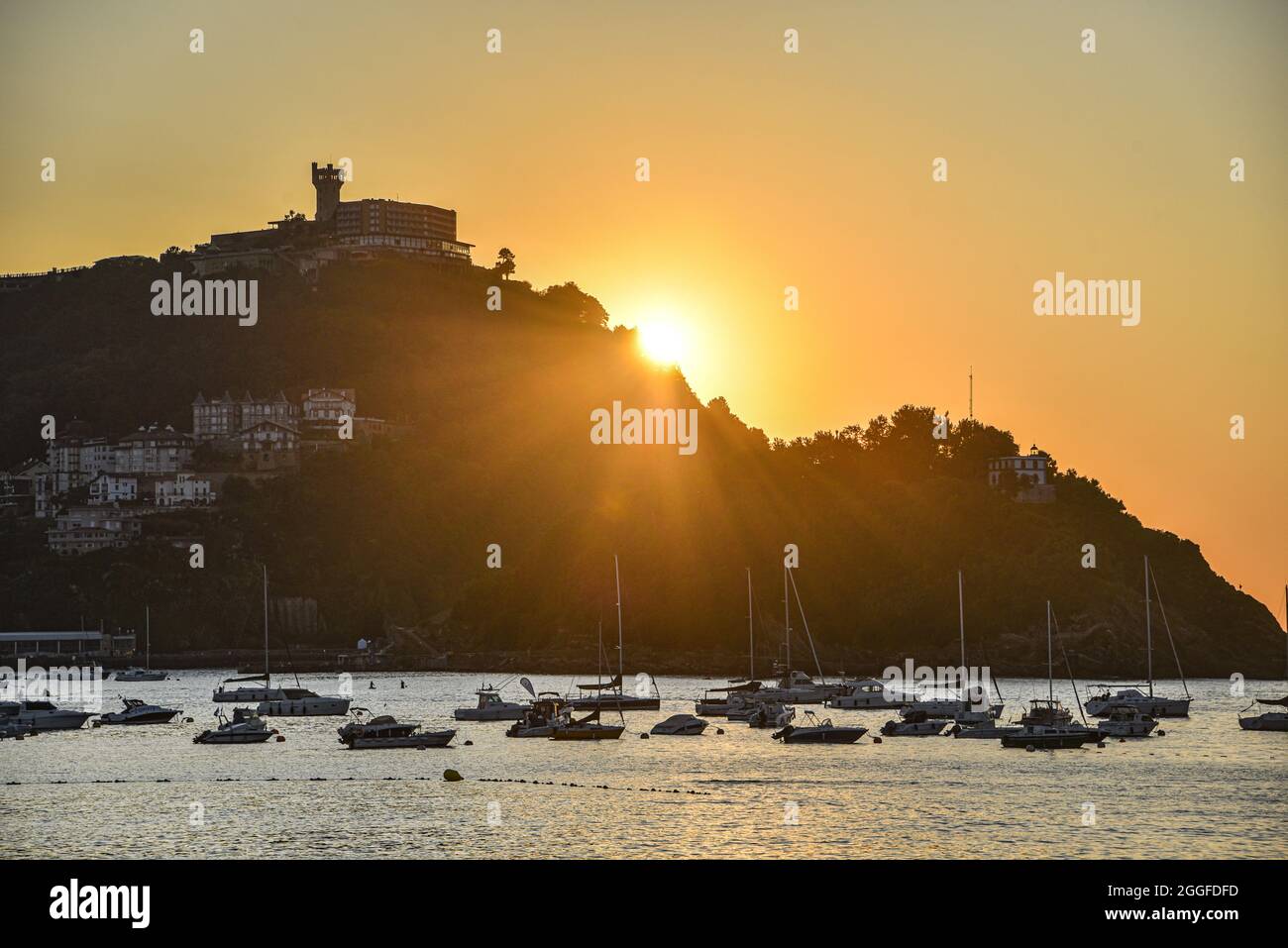 San Sebastián, España - 29 de agosto de 2021: Puesta de sol de verano sobre Monte Igeldo y la bahía de La Concha Foto de stock
