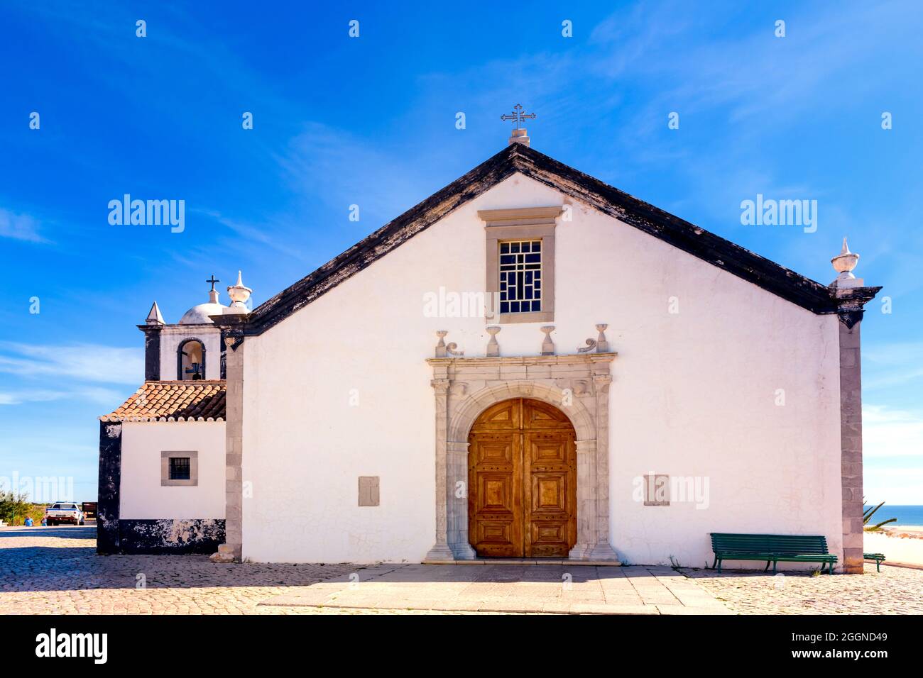 La capilla de la iglesia católica pintada de blanco de Igreja de Nossa Senhora da Assunção contra un cielo azul con espacio de copia Cacelo Velha Algarve Portugal Foto de stock