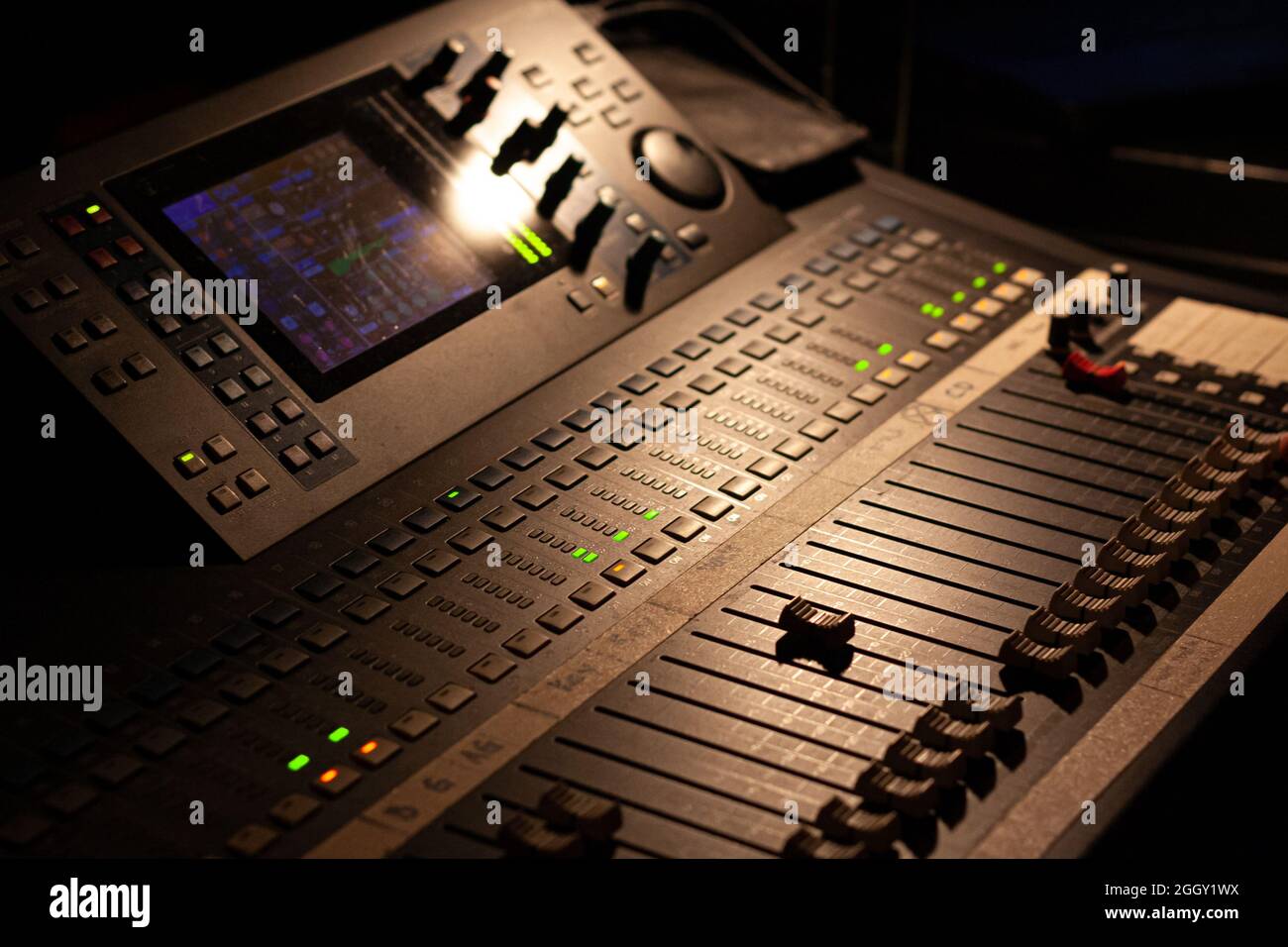 grabación ambiental de un moderno dispositivo de mezcla de audio digital para una mezcla de sonido profesional en un concierto con poca luz parcial Foto de stock