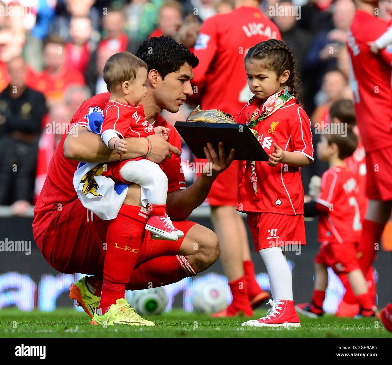 Luis Suarez de Liverpool muestra a su hija su premio de oro durante el partido de Barclays Premier League entre Liverpool y Newcastle United en Anfield en Liverpool, Reino Unido,