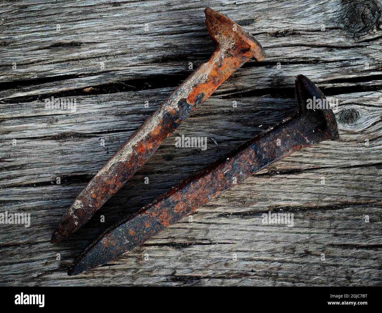 Los viejos clavos del ferrocarril de acero oxidados del hierro en la  superficie de madera Fotografía de stock - Alamy