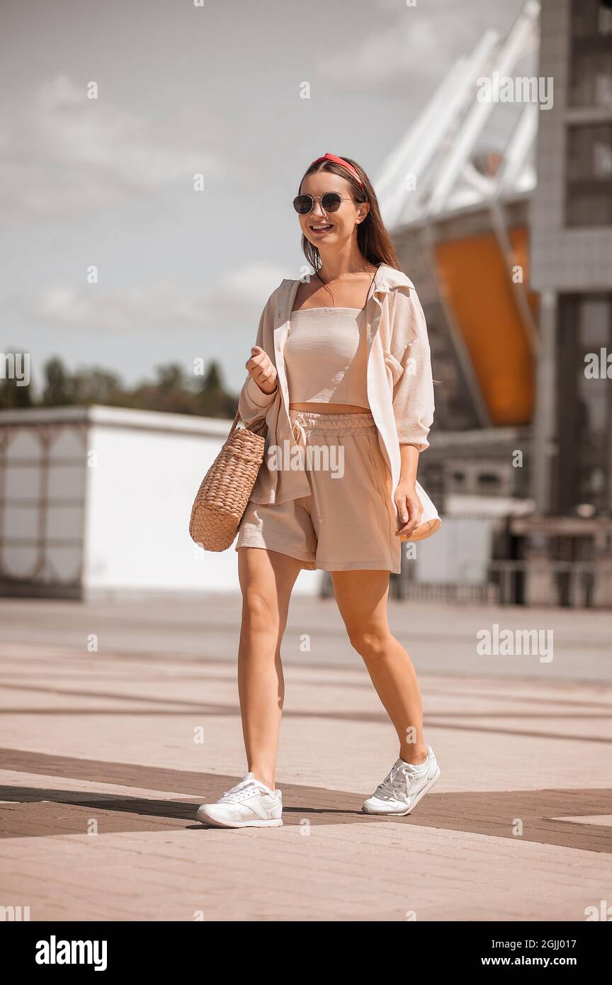 Una mujer joven y bonita con ropa de color beige en la calle Fotografía de  stock - Alamy